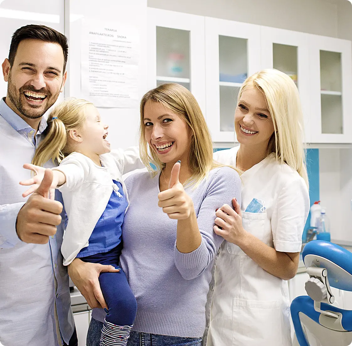 Family smiling at the dentist's office.