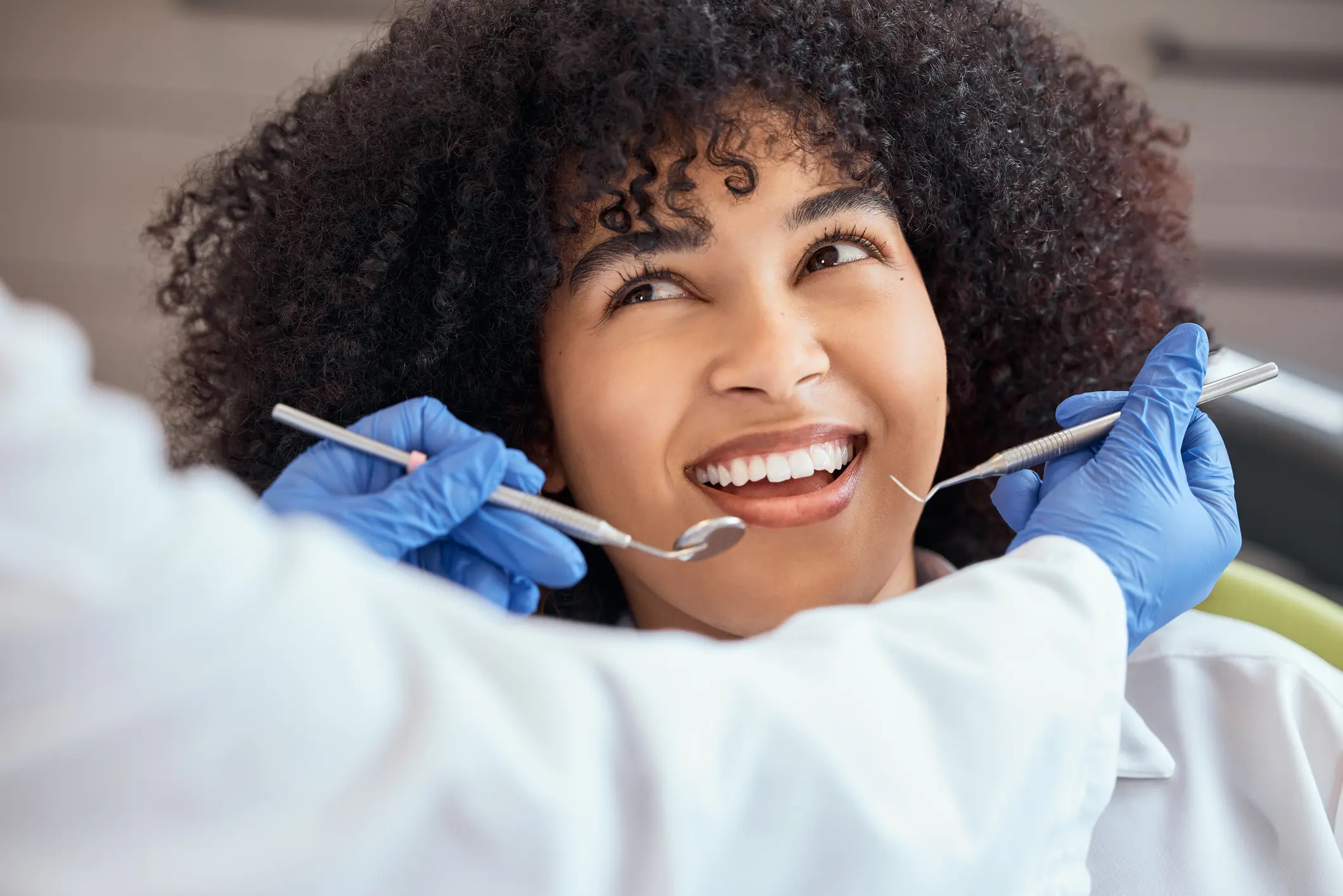 Woman smiling during dental check-up.
