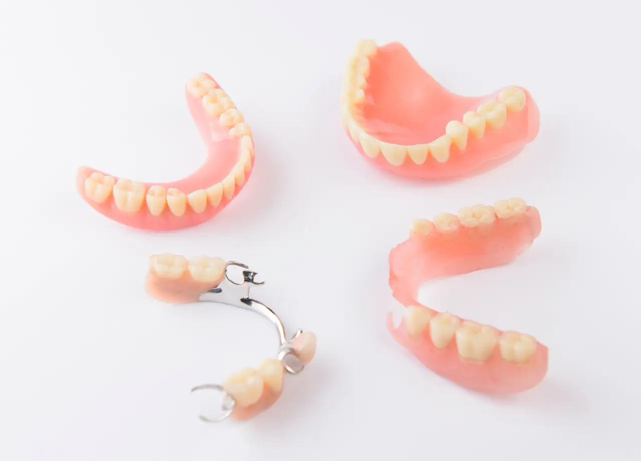 Set of various dental prosthetics on white.